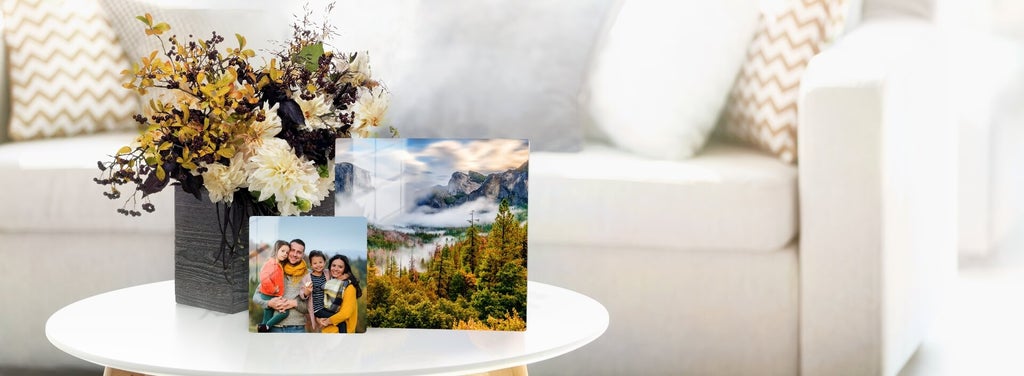 Two photos on metal decorate a coffee table with elegance.